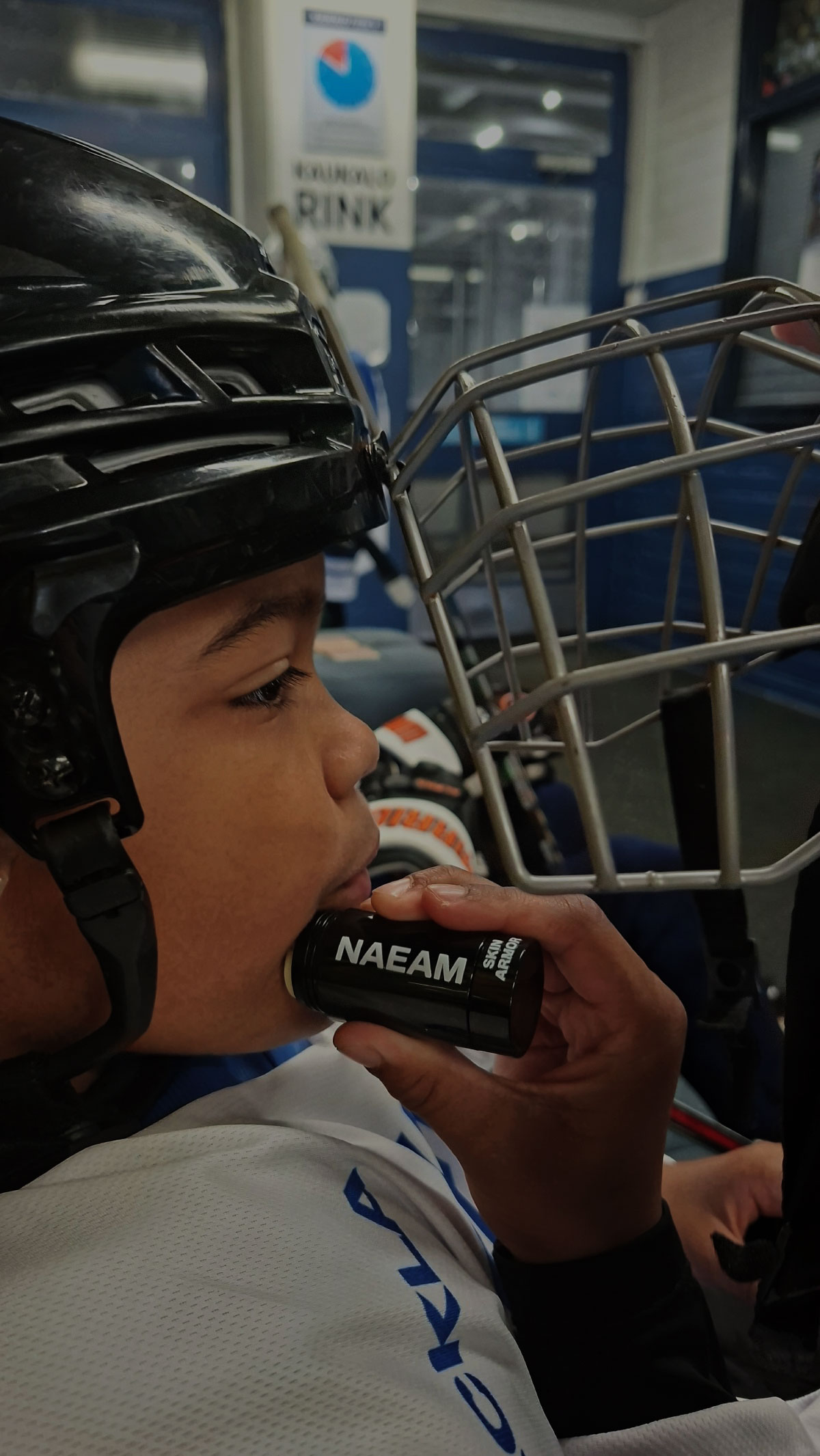 Young hockey player applying Skin Armor